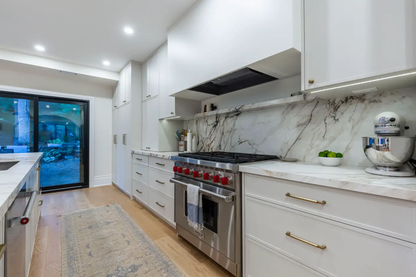 Kitchen with Wolf gas range and full-height marble slab backsplash