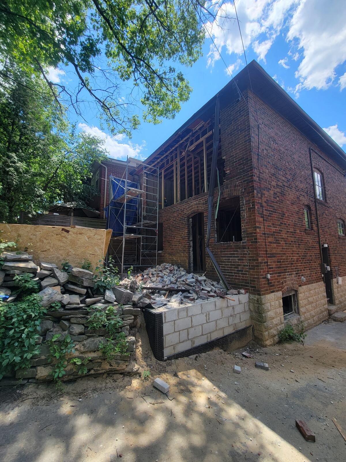 Rear addition under construction with scaffolding and new block foundation