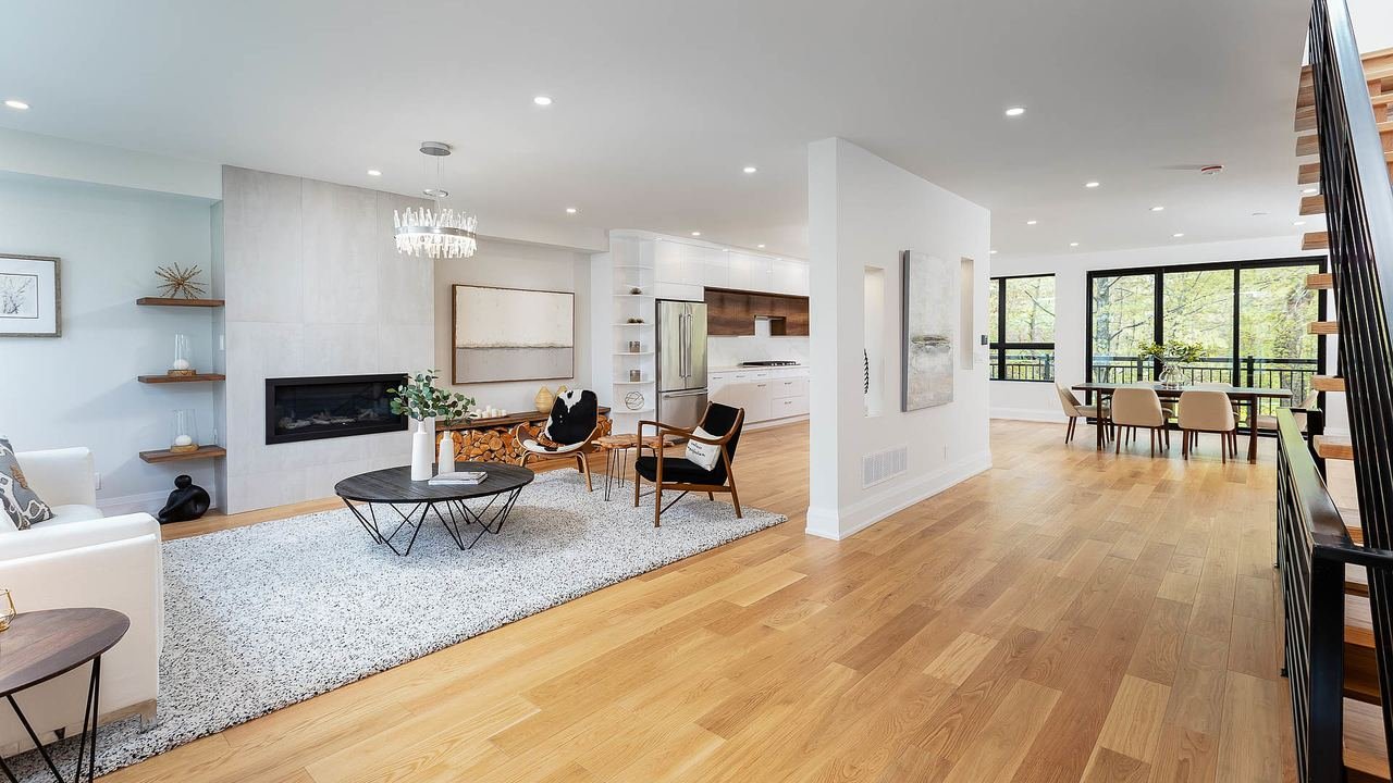 Open concept living and dining space with linear fireplace