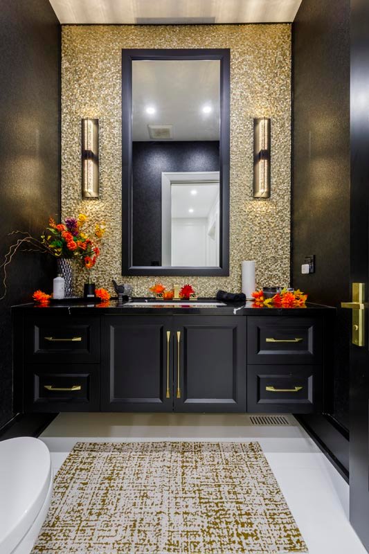 Powder room with gold mosaic feature wall and black vanity