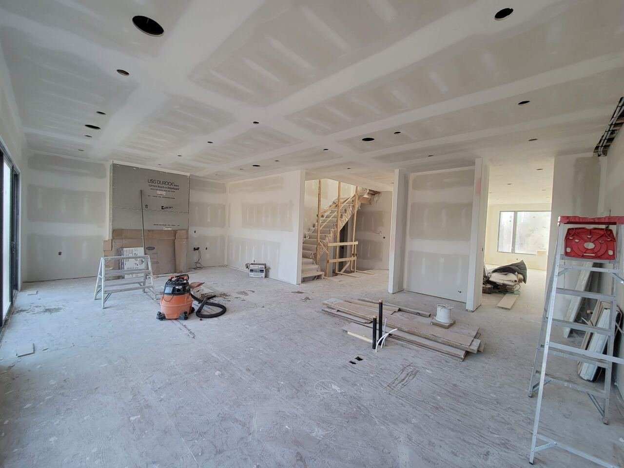 Main floor at drywall stage with new staircase framed