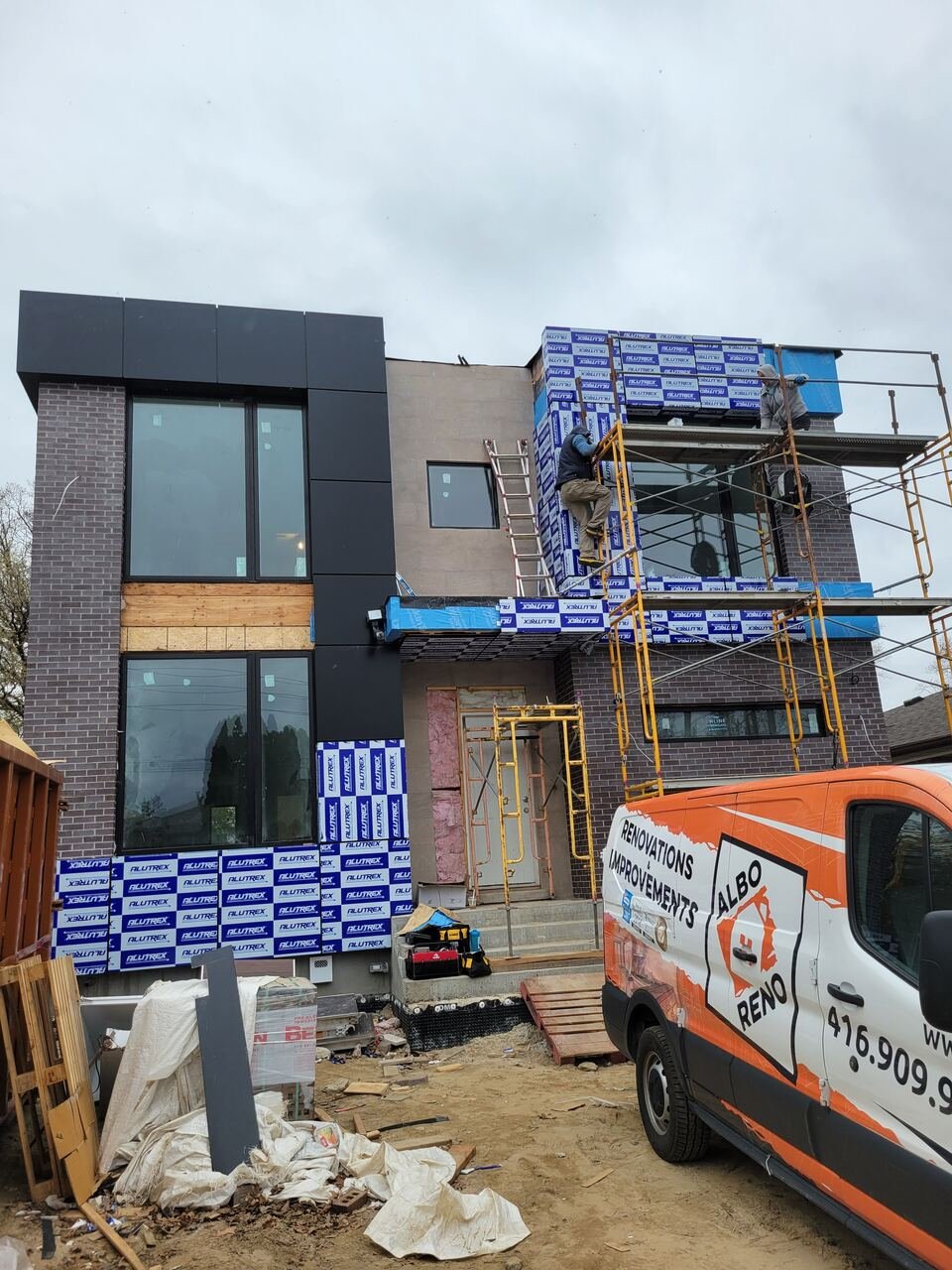 Exterior brick and panel cladding installation from scaffolding