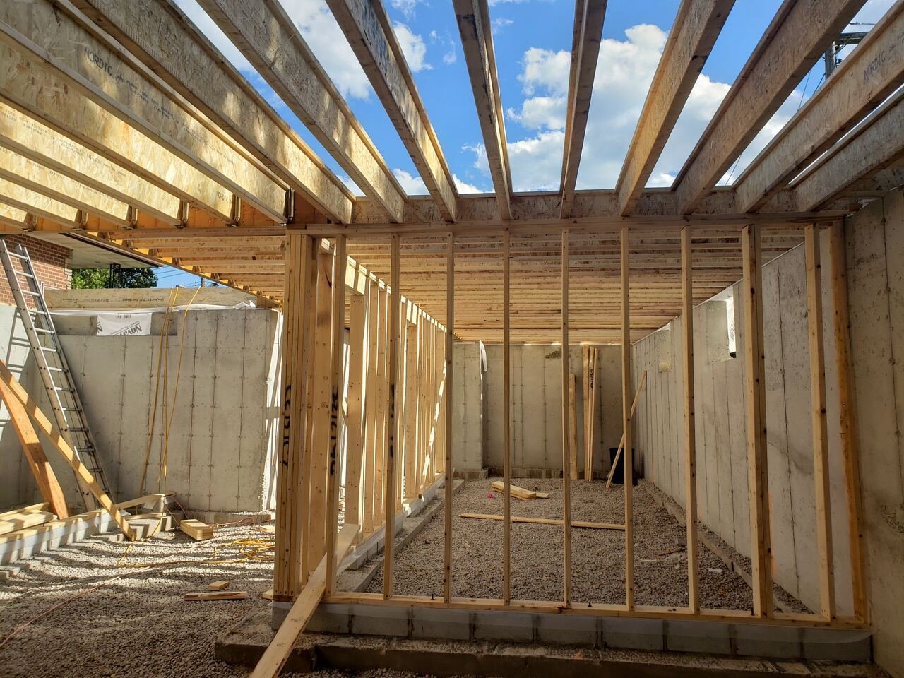 New foundation walls and floor joists during framing stage