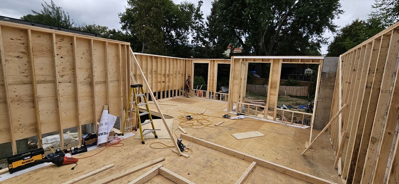 Wide view of the main floor framed with new stud walls and subfloor