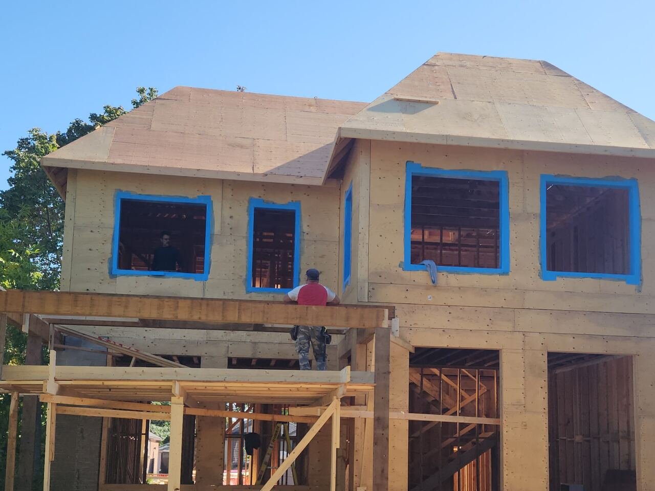 Second storey sheathed with window openings taped and ready for install