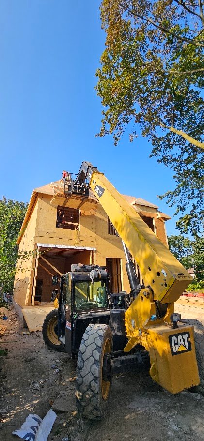 Telehandler lifting materials to the second storey during sheathing