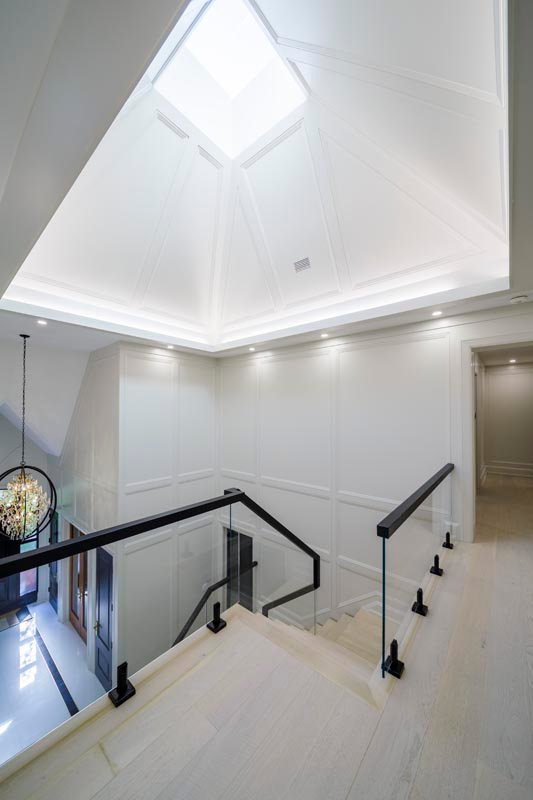 Staircase landing with skylight and vaulted ceiling