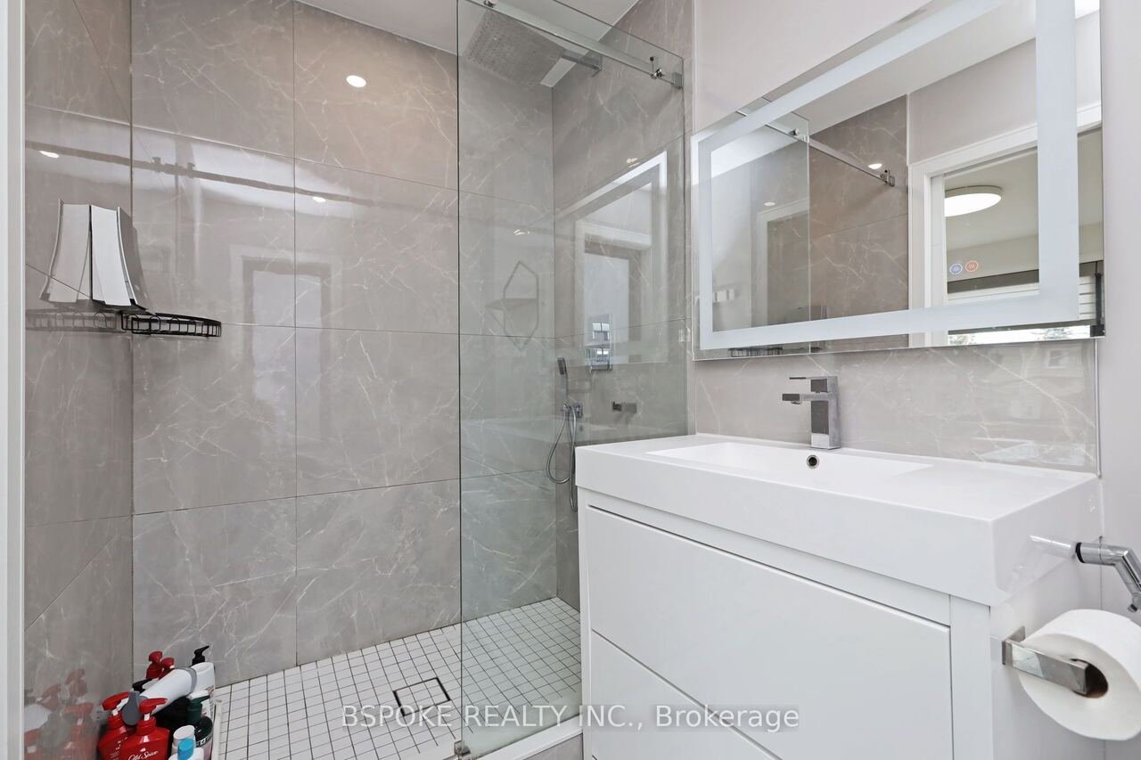 Bathroom with grey tile walk-in shower and rain head