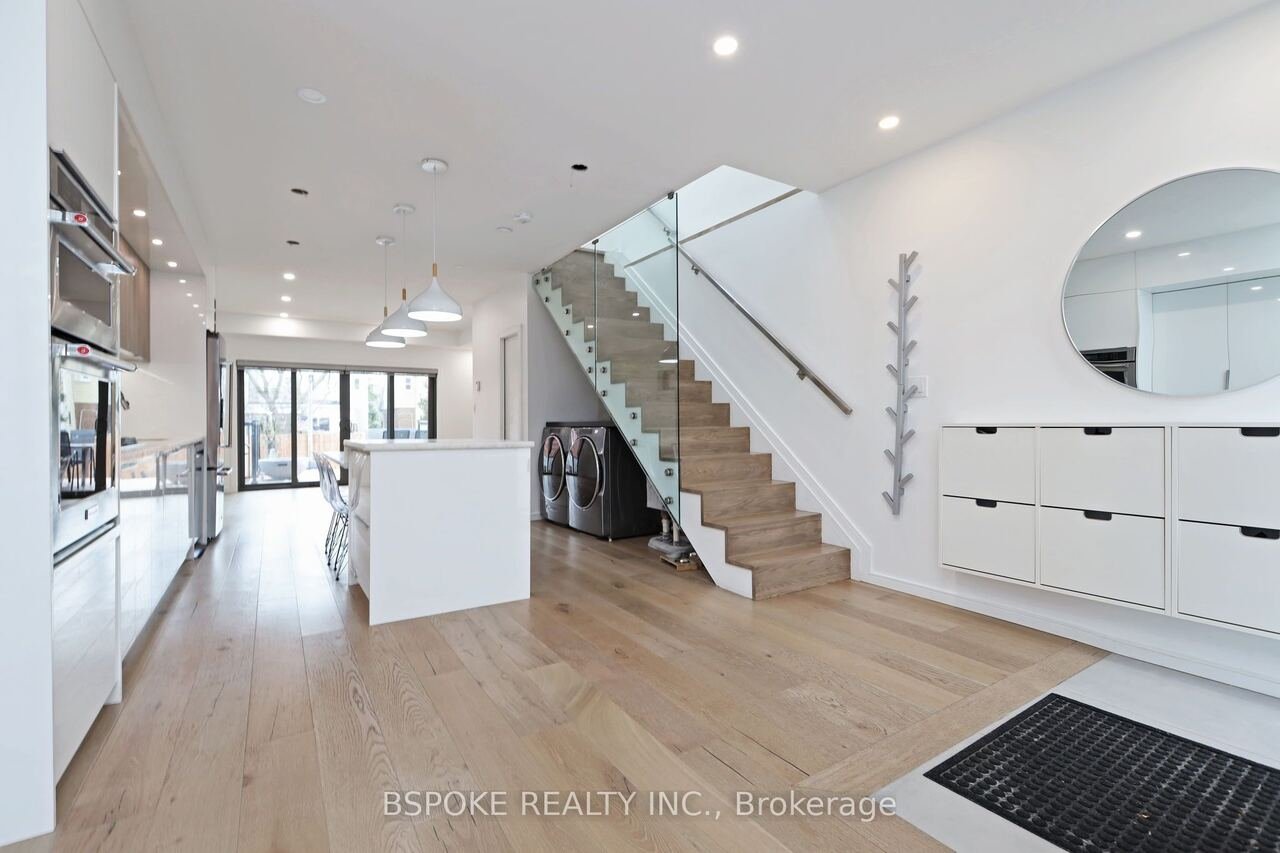 Open concept main floor from the rear doors to the front entry