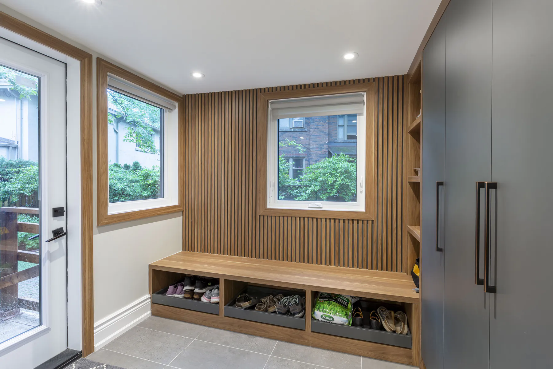 Mudroom with wood slat wall and built in bench