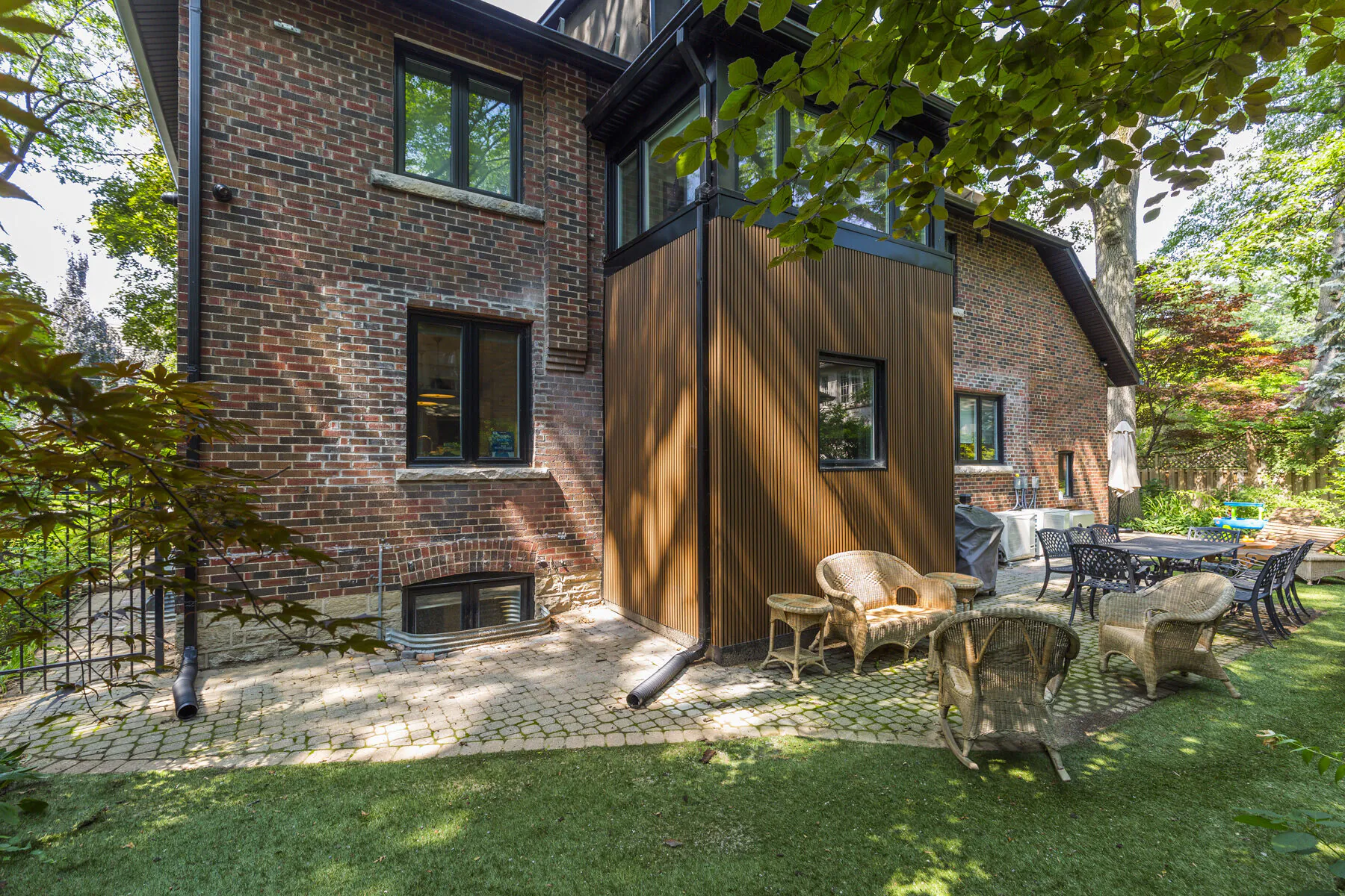 Rear addition with wood siding on brick home