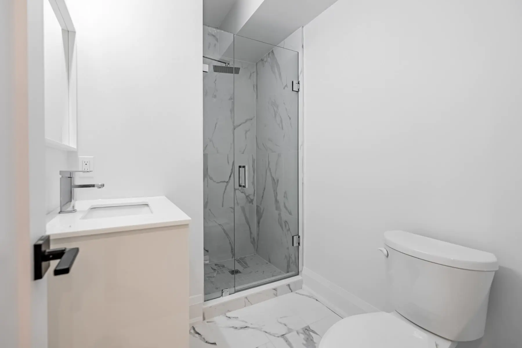 Bathroom with marble tile and glass shower