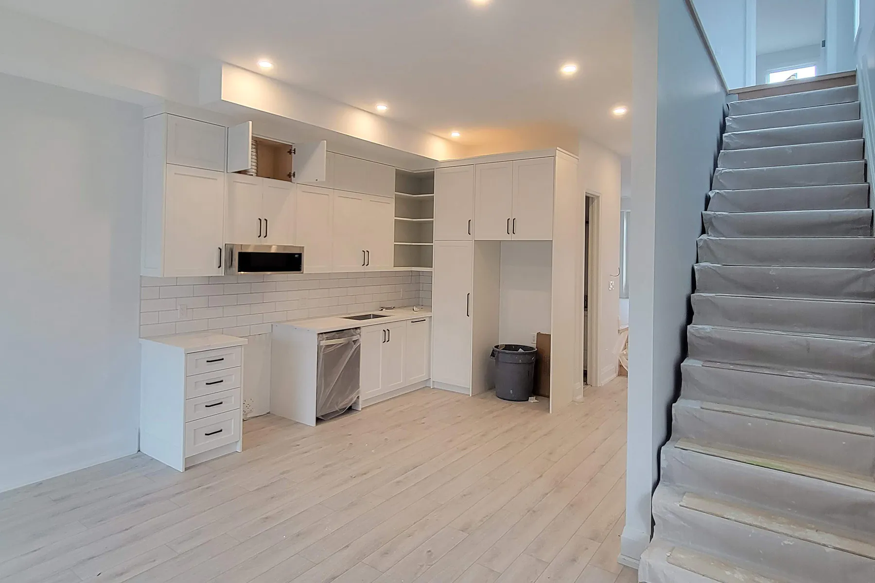 Main floor cabinetry and staircase during finishing