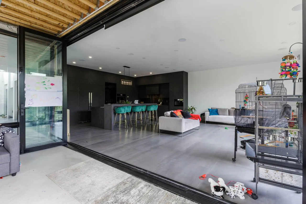 Covered patio with open full-width sliding doors into kitchen