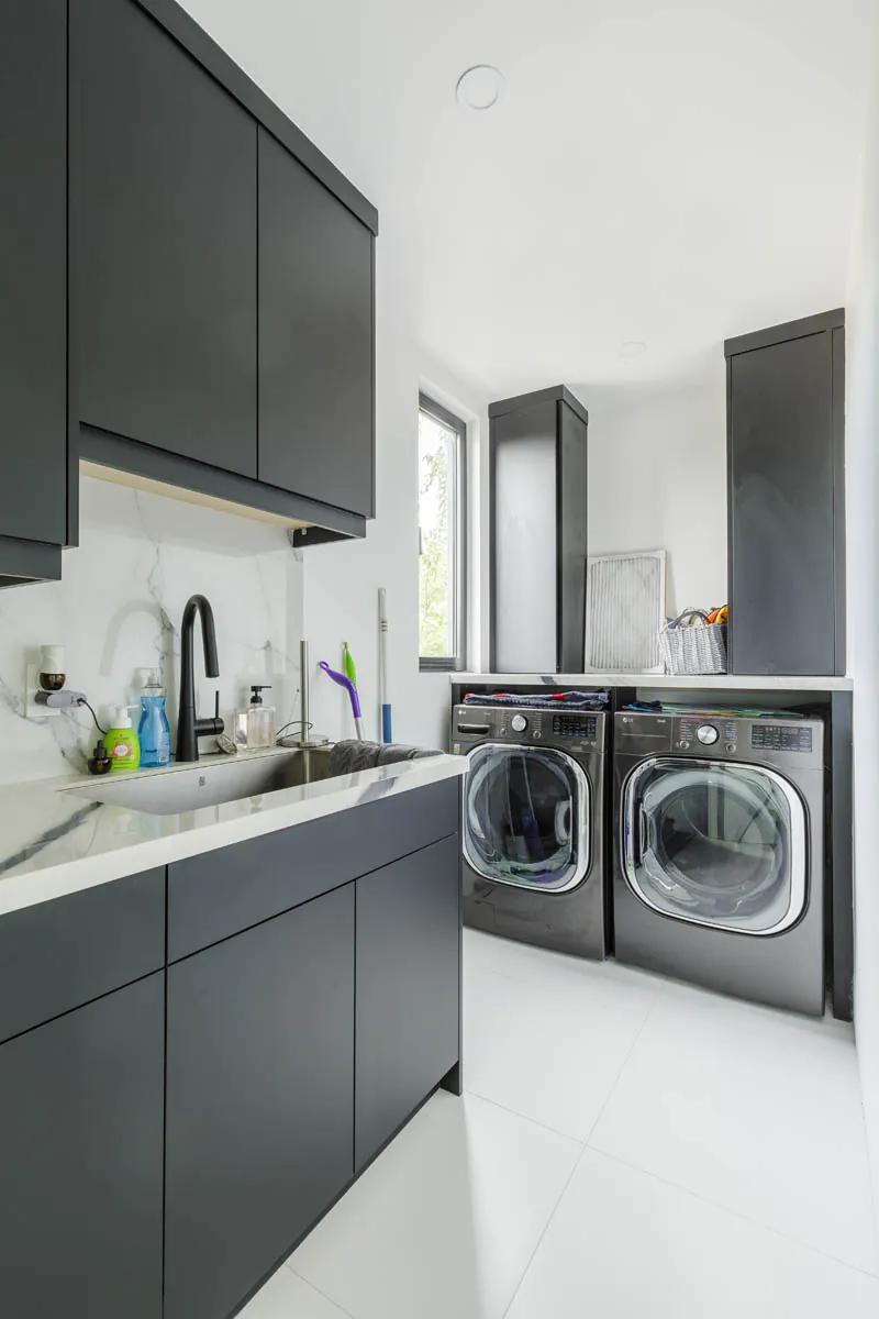 Laundry room with black cabinetry