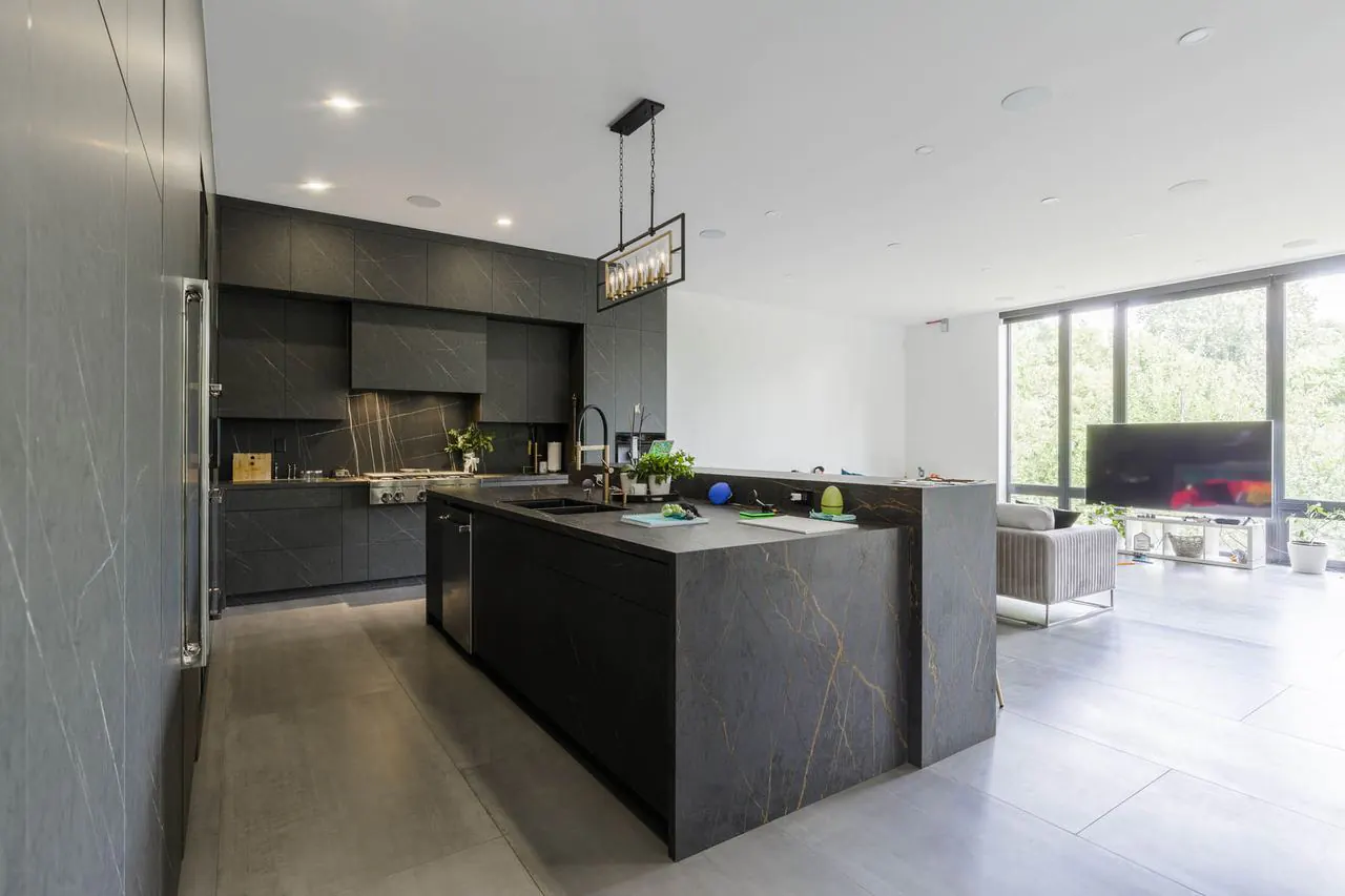 Open concept kitchen with view to L-shaped living and dining space