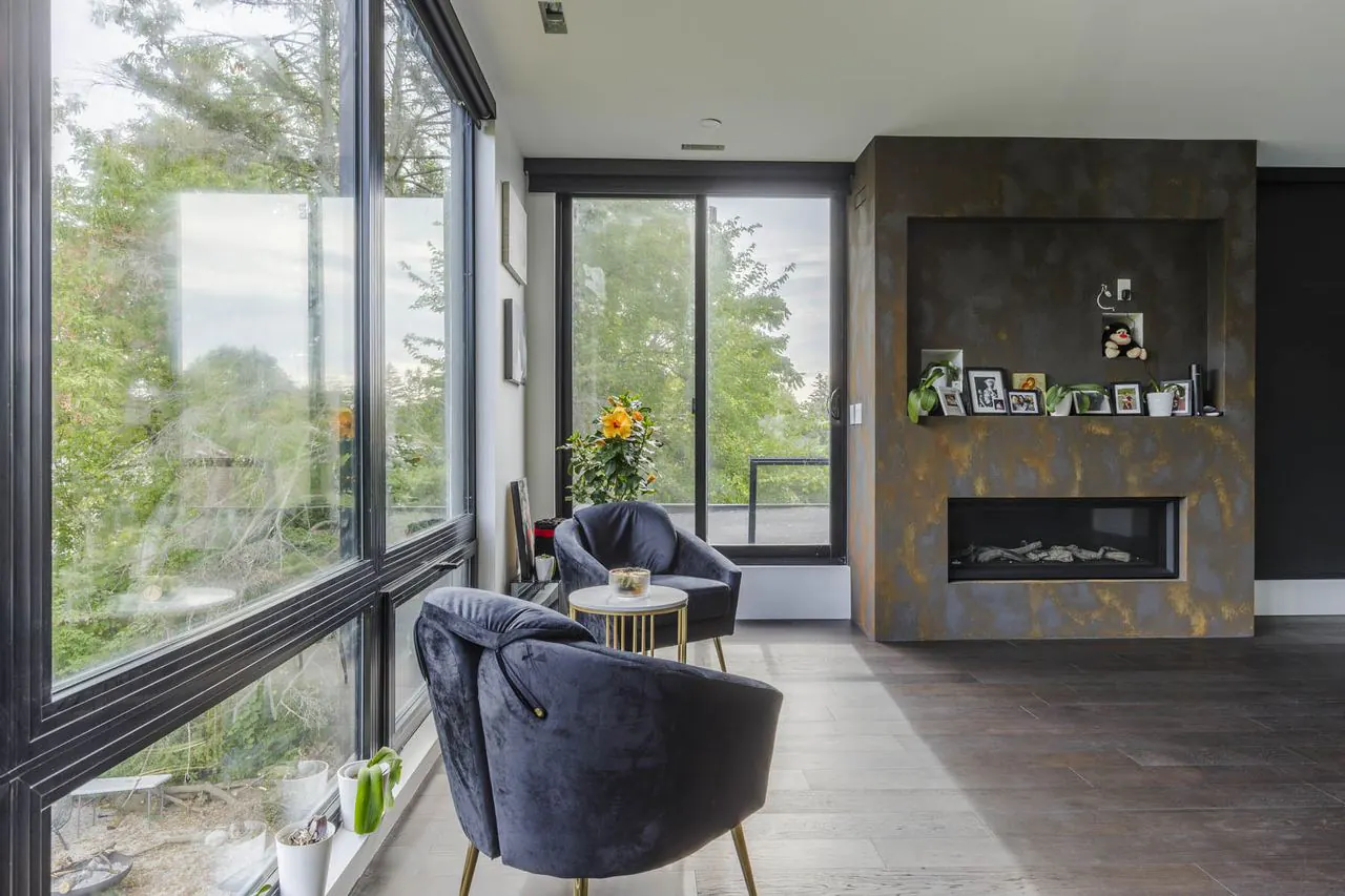 Sitting area with fireplace and floor-to-ceiling windows