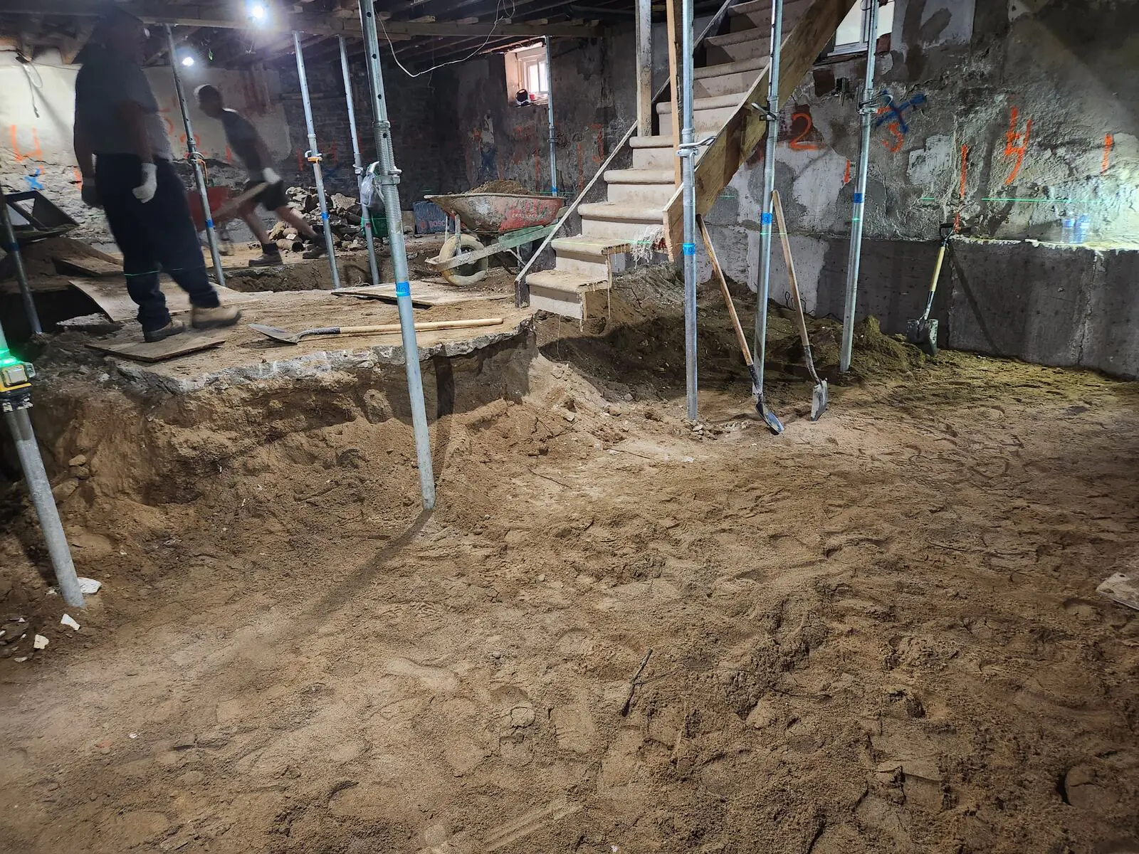 Crew excavating the basement during full-height underpinning