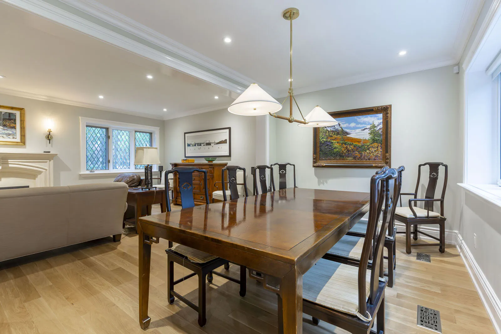 Renovated dining room with brass pendant lighting, leaded glass windows and white oak flooring