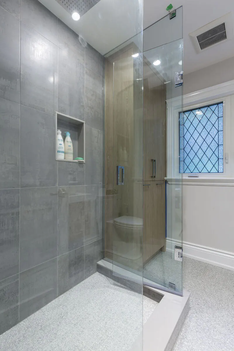 Renovated ensuite bathroom with glass walk-in shower and patterned tile