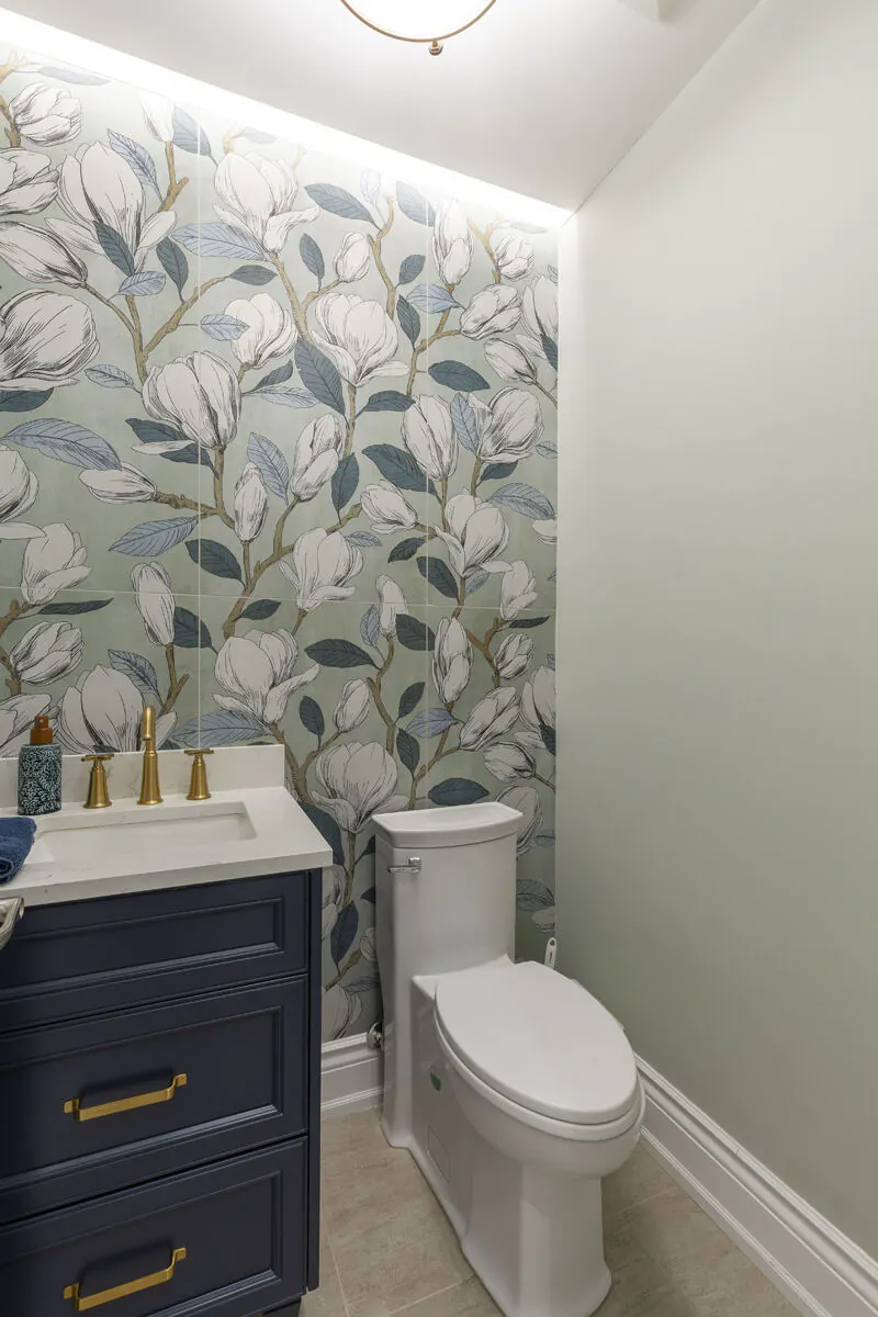 Renovated powder room with magnolia wallpaper and marble counter