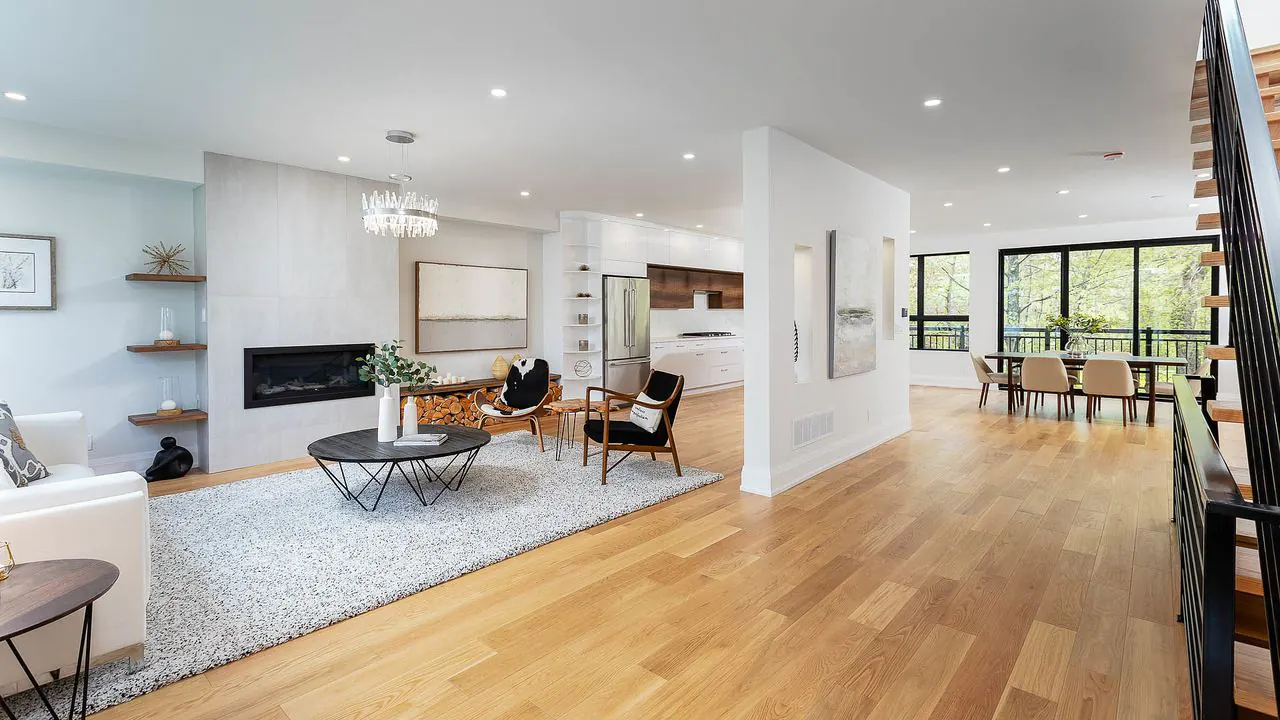 Open concept living and dining space with linear fireplace