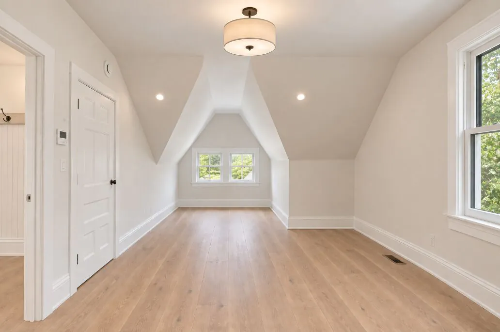 Third floor living space under the original roofline, with dormer window and new flooring
